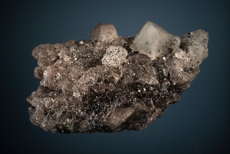 PHENAKITE with HEMATITE on QUARTZ
