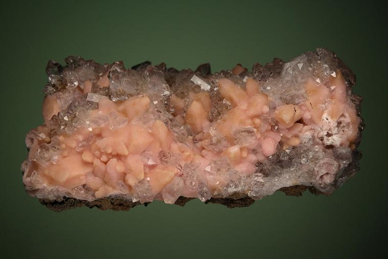 RHODOCHROSITE after CALCITE on QUARTZ var. Amethyst