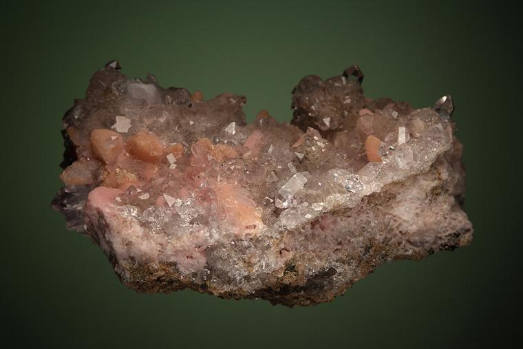 RHODOCHROSITE after CALCITE on QUARTZ var. Amethyst