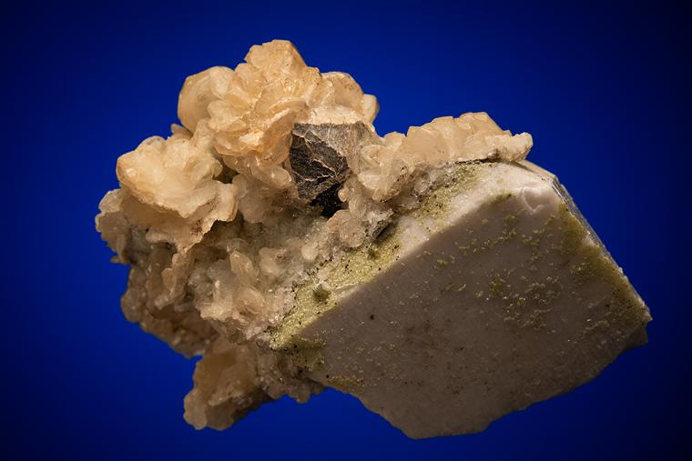 CALCITE with MUSCOVITE on ALBITE and MICROCLINE